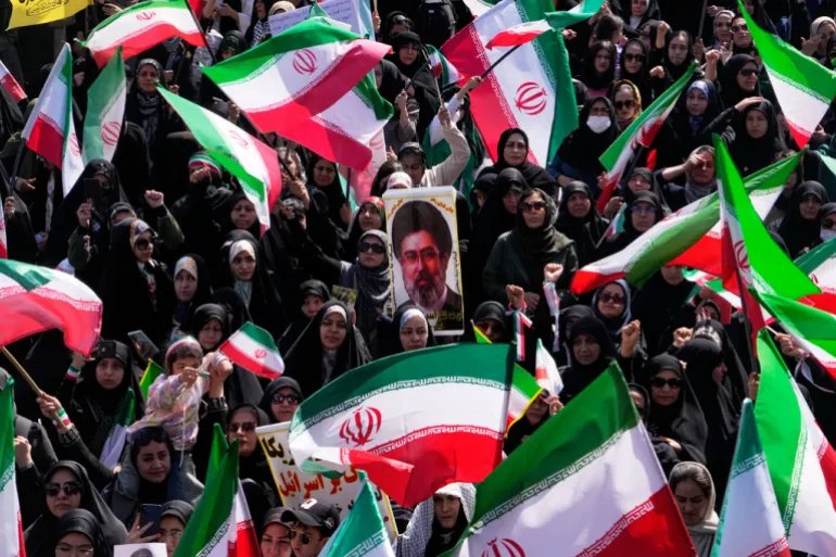 Iranian flags with photo of mojtaba