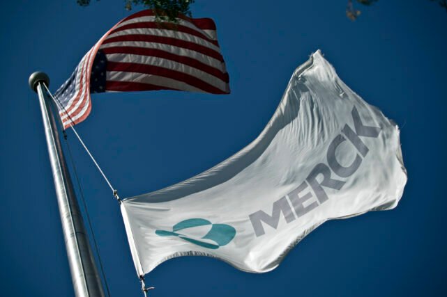 SUMMIT, NJ - OCTOBER 2: A Merck flag flies in front of the company's building on October 2, 2013 in Summit, New Jersey. The pharmaceutical company Merck & Co. announced today that it would cut 8,500 jobs and consolidate its real estate in Kenilworth, New Jersey instead of moving its headquarters to Summit as previously planned. 