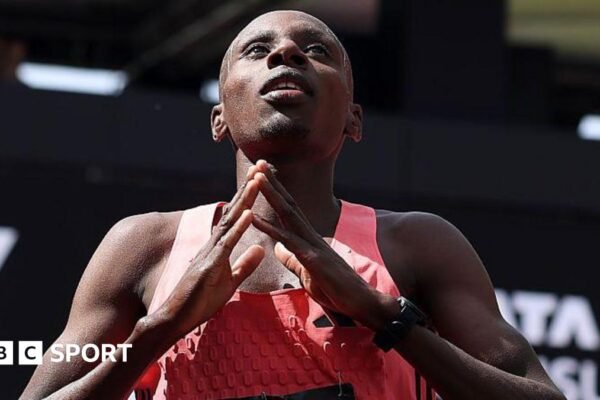 Sabastian Sawe holds up the Adidas supershoe which he wore in breaking the marathon world record in London
