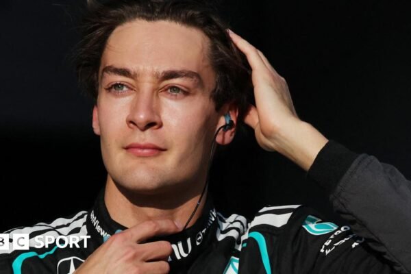 George Russell runs his right hand through his hair as he prepares for the start of the 2026 Japanese Grand Prix