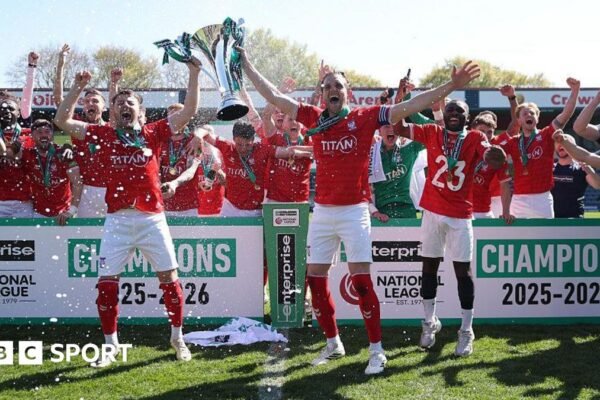 Ollie Pearce and Callum Howe of York City lift the National League Trophy after the 1-1 draw at Rochdale