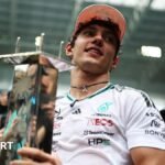 Kimi Antonelli holds his winner's trophy in Miami
