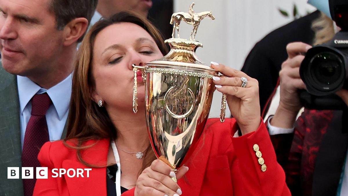 Cherie DeVaux kisses the Kentucky Derby trophy