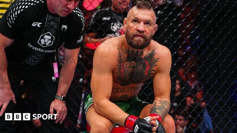 Conor McGregor sits on a stool