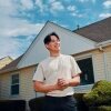 Francisco Vazquez, 27, stands in front of his new home in Milwaukee, Wis. He was able to buy it after changing his career track and saving aggressively, including for one year while he lived rent free with his parents.