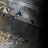 A satellite image of destroyed planes at Mehrabad Airport in Tehran, Iran on March 7 with a fuzzy black screen covering up the right half of the image.