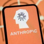 The Anthropic logo is displayed on the screen of a smartphone with the company's branding in the background.