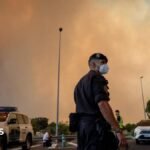 A person runs as the fire spreads in the mountains of Navaluenga, Avila, Spain