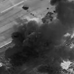 A black and white thermal imagery screengrab showing a US strike on a target in Iran.