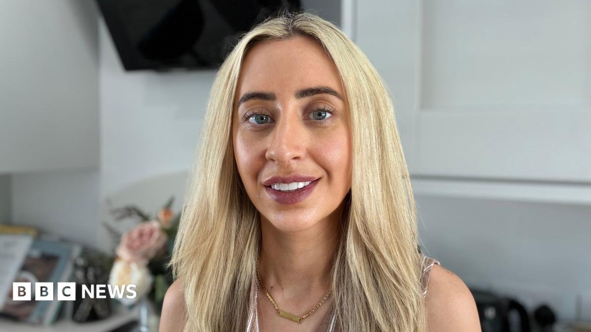 A woman with blonde hair smiling at the camera