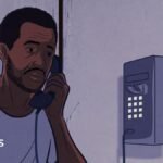 An illustration of a man on a wall-mounted telephone. He is wearing a white T-shirt and orange trousers. Some prison bars can be seen on the left of the image.