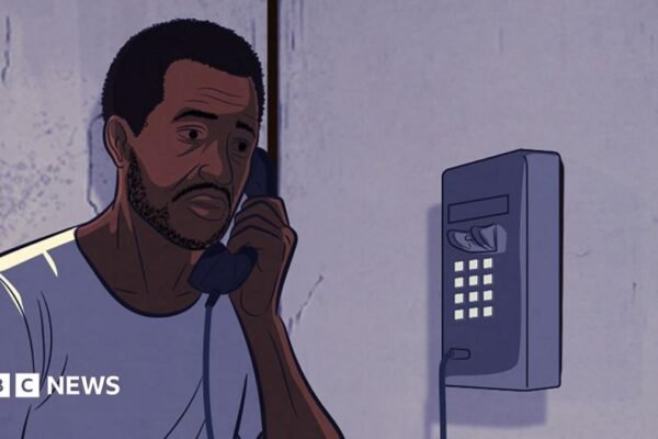 An illustration of a man on a wall-mounted telephone. He is wearing a white T-shirt and orange trousers. Some prison bars can be seen on the left of the image.