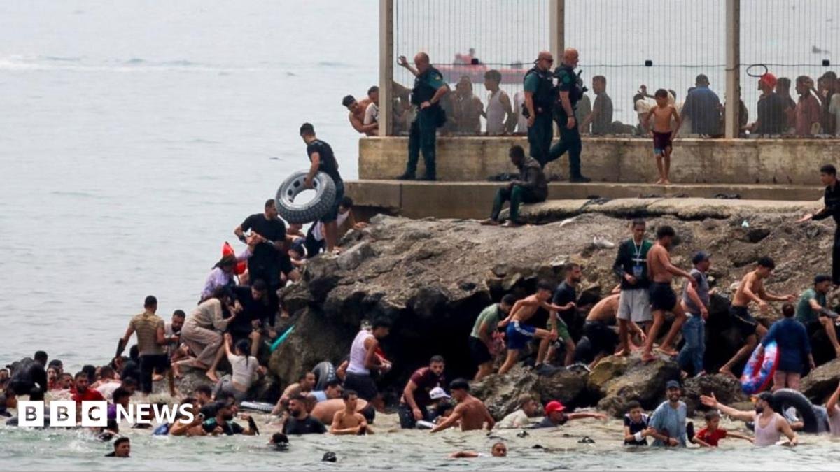 migrants swimming into Ceuta