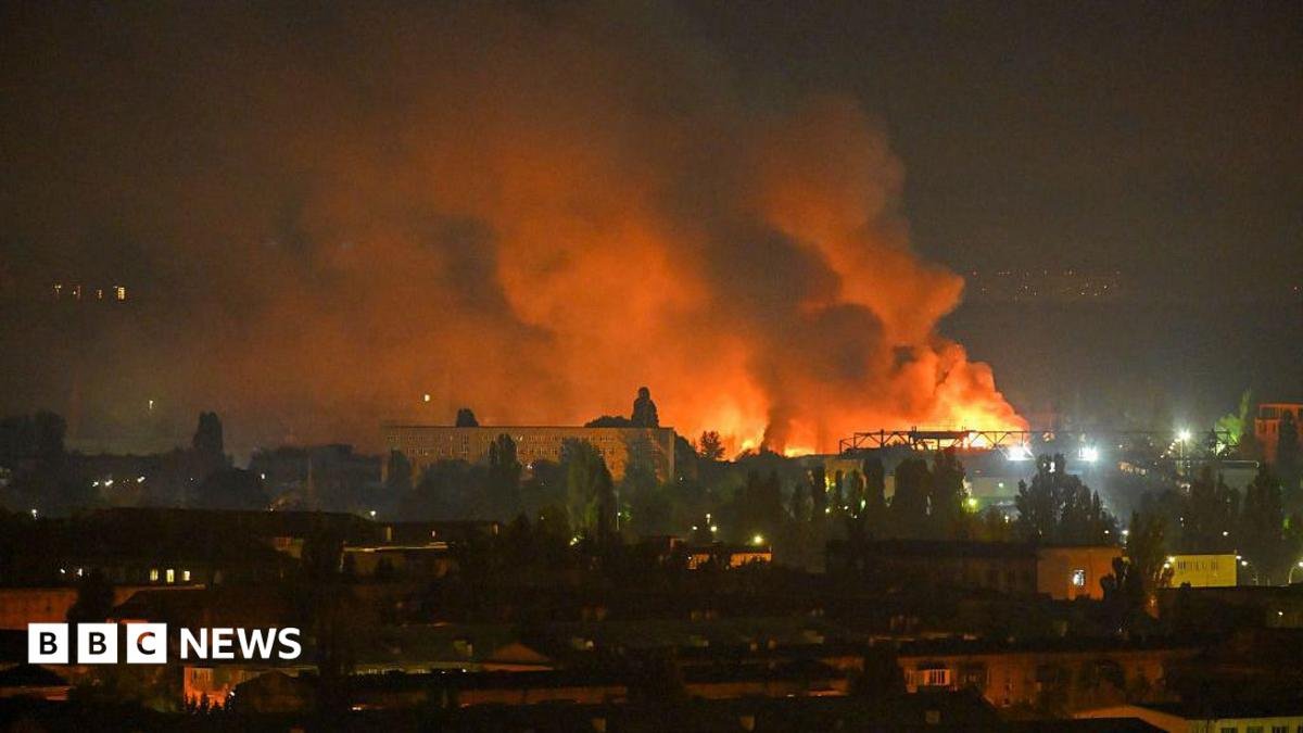 A fire breaks out following massive Russian ballistic missile strikes in the Ukrainian capital of Kyiv, with orange and black plumes of smoke expanding across the night sky.